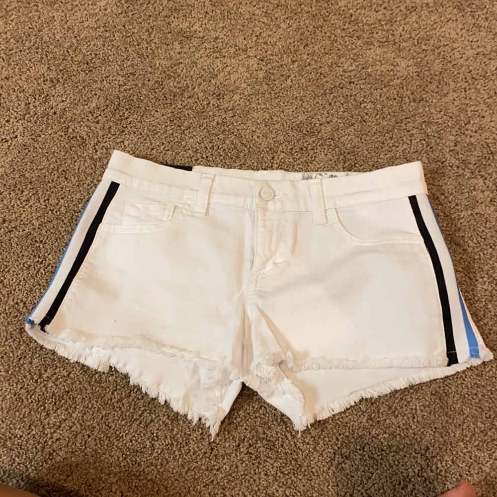 White jean shorts with blue strips on the side.